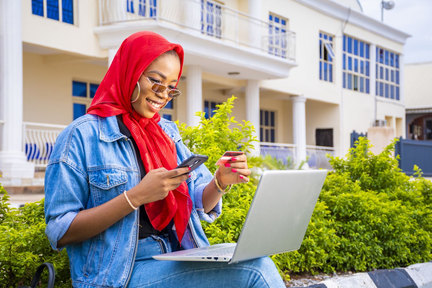 Should you pay for online courses - Young woman with laptop and phone researching paid vs free course options outdoors